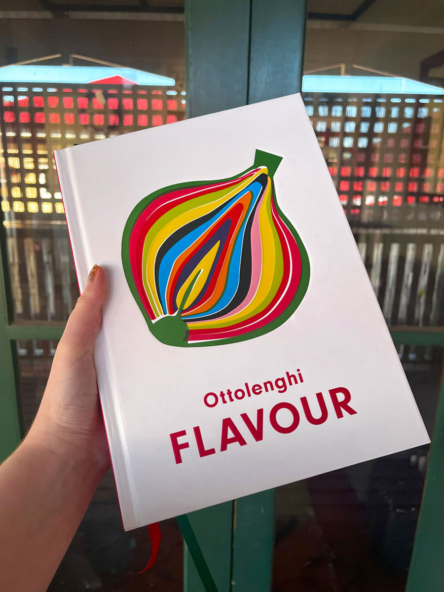 The book "Flavour" by Ottolenghi being held up