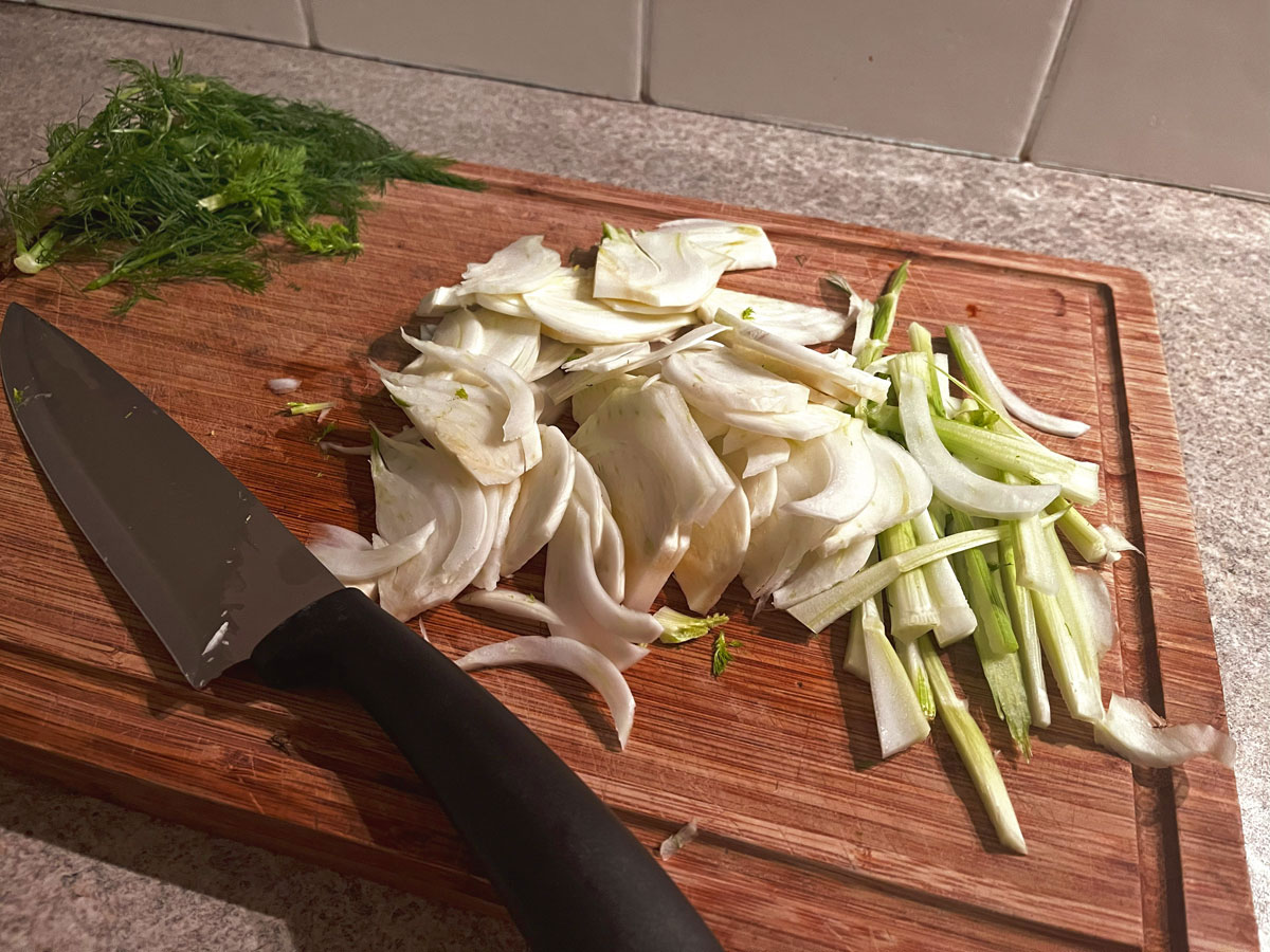 sliced raw fennel on chopping board with knife